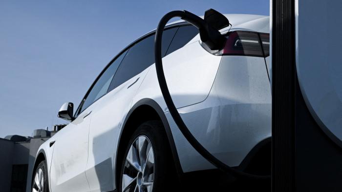 FILE PHOTO: A Tesla car being charged at a Tesla electric vehicle charging station in a car park of the A10 shopping center in Wildau near Berlin, Germany, March 20, 2024. REUTERS/Annegret Hilse/File Photo