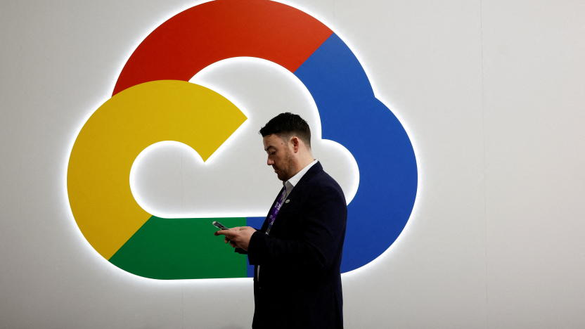 A person looks at their phone in front of the Google Cloud logo, at the 2024 Mobile World Congress (MWC) in Barcelona, Spain February 27, 2024. REUTERS/Albert Gea